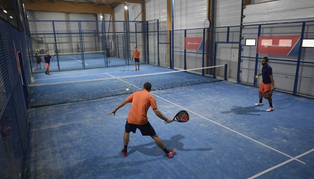 People get the action going in a game of padel. (Stephane De Sakutin/AFP)